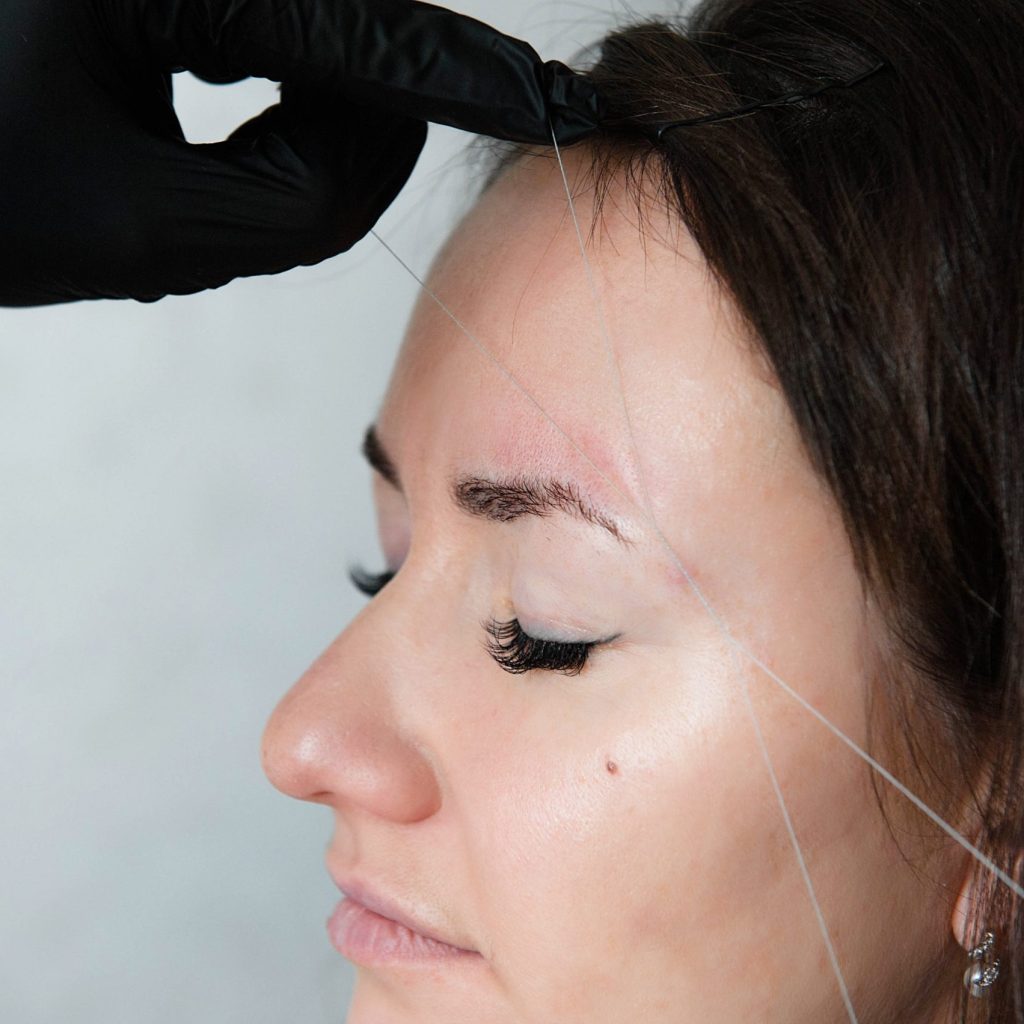 Browist makes eyebrow correction with tweezers